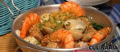 a large pot filled with shrimp and clams on top of a table next to a basket