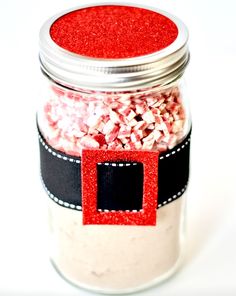 a jar filled with red and white sprinkles