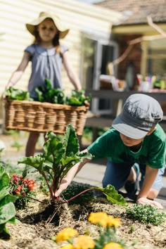 two children are in the garden with plants