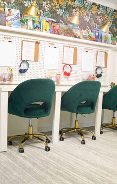 three green office chairs sitting in front of a white board with pictures on the wall