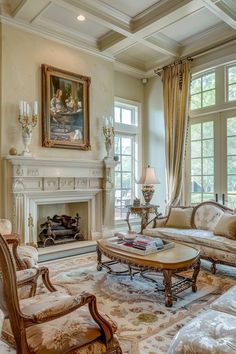 a living room filled with furniture and a fire place in front of a painting on the wall