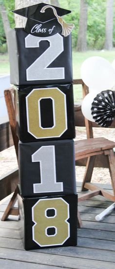 a stack of black and gold blocks with the number one on them in front of a picnic table