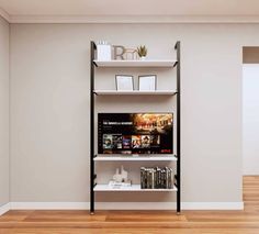 an empty room with a book shelf and books