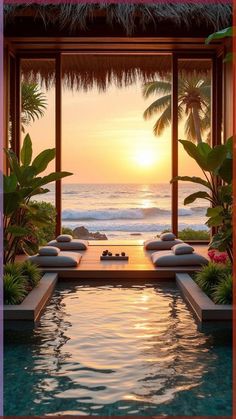 an outdoor swimming pool with sun setting over the water and palm trees in the background