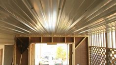 the inside of a house that is being built with metal sheeting on the ceiling