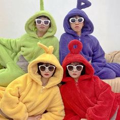 three people in animal onesuits sitting on a couch with one person wearing sunglasses