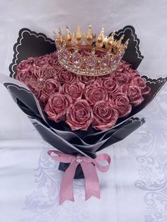 a bouquet of roses with a crown on top