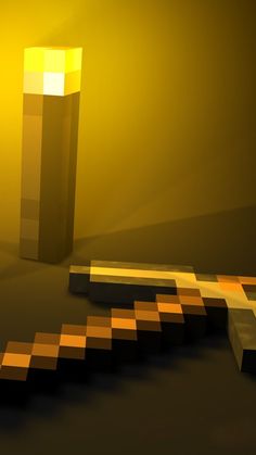 an abstract photo of a yellow vase and some blocks on the ground in front of it