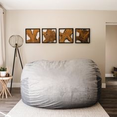 a large bean bag chair sitting on top of a wooden floor