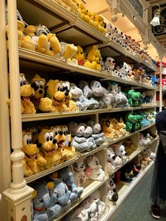 a woman is looking at stuffed animals in a store