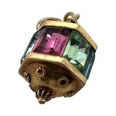 This is part of Chairish’s Fine Jewelry assortment.  This is a fun vintage 14K gold charm or pendant in the Victorian style. The gold tests 14k and the jump ring is also marked. The top and bottom have Etruscan beadwork. There are alternating faceted rectangular glass of pastel colors. Condition is excellent.  Dimensions: Height: 20mm; Width: 11mm; Weight: 4.7 grams Vintage Yellow Gold Charms For Jewelry Making, Victorian 14k Gold Jewelry With Vintage Charm, Victorian Yellow Gold Jewelry With Vintage Charm, Vintage 14k Gold Pendant Charms, Vintage 14k Gold Charms, Vintage Etruscan Jewelry, Vintage Tarnish-resistant Yellow Gold Charm Necklaces, Antique Yellow Gold Pendant Charms, Victorian Yellow Gold Vintage Charm