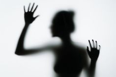 the shadow of a woman holding her hands up