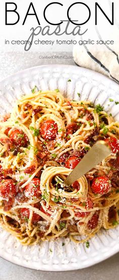 a white plate topped with pasta covered in sauce