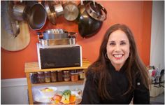 a woman sitting in front of a counter filled with food