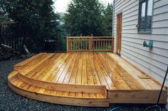 a wooden deck in front of a house