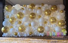 balloon wall with gold and white balloons