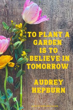 there are flowers on the wooden table with an inspirational quote about garden is to believe in tomorrow