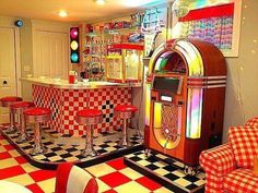 a room with red and white checkered flooring and an old fashioned jukebox