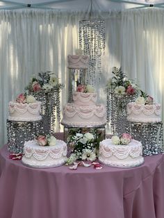 a table topped with three tiered cakes covered in frosting