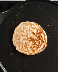 a pancake is being cooked in a skillet