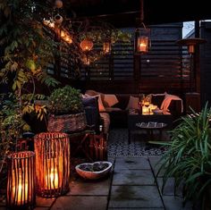 an outdoor living area with plants and lights