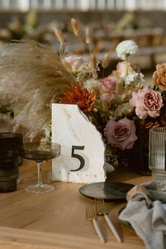 the table is set with flowers and candles