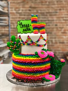 a multicolored cake is sitting on a table