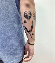 a person with a flower tattoo on their arm