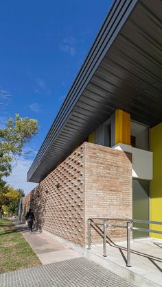 the side of a building that is made out of bricks and metal, with stairs leading up to it