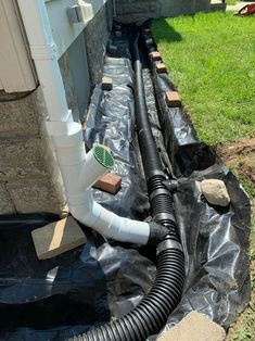 an image of a drain system installed in the ground for drainage work on a house