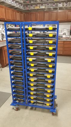 a blue rack with yellow and black trays on it