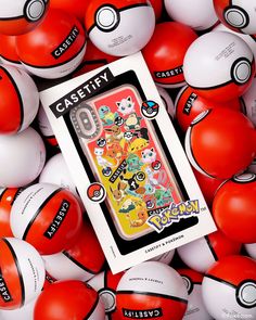 an unopened pokemon card surrounded by many red, white and black balls with cartoon characters on them