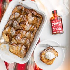 a pan filled with cinnamon french toast next to a bottle of canadian maple syrup