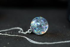 "This is the original fairy bubble necklace - the first, and the rainbowiest. A globe of fairy bubbles... beautiful, beautiful rainbow bubbles that change colour as they catch the light from different angles; the bubbles are swirling throughout the necklace, all different sizes, like they've just been blown. We have captured something as fleeting as bubbles, and made them keepable for always <3 They are available in 2 sizes: 21mm across, and its diddy little sister, who is just 15mm across. Tiny Rainbow Color Necklace For Gift, Unique Party Necklaces, Magical Iridescent Necklace Gift, Iridescent Round Necklace For Gifts, Iridescent Round Necklace For Gift, Magical White Jewelry As Gift, Magical White Jewelry As A Gift, Fairy Bubbles, Faery Jewelry