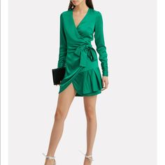 Brand New, Just Tried On. Exclusive-To-Intermix. Effortlessly Luxurious, This Emerald Satin Wrap Dress Was Designed For Partying, Lounging, And Capturing The Hearts Of Admirers. A Charming Ruffle Hem Ensures All Eyes Are On You. Wear Yours With A Pair Of Nude Heels And A Tangle Of Delicate, Sparkly Necklaces. Crossover V-Neck. Attached Wrap Belt Closure At Side Waist. Long Sleeves With Gathered Buttoned Cuffs. Unlined. In Emerald Green. Style Number: Komosa-Excl Fabric: 86% Rayon/14% Polyester L Chic Party Wrap Dress With Ruffles, Elegant Ruffled Wrap Dress For Date Night, Fitted Ruffled Wrap Dress For Party, Elegant Fitted Wrap Dress With Ruffles, Elegant Mini Wrap Dress With Ruffles, Fitted Wrap Dress With Ruffles For Date Night, Chic Green Mini Dress For Dinner, Elegant Wrap Dress With Ruffles For Night Out, Ruffled Wrap Dress For Night Out