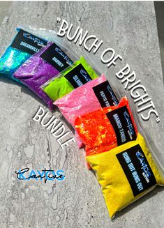 three bags of candy sitting on top of a cement surface with the words bunch of brights