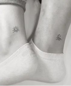 two small sun and moon tattoos on their legs, both with the same tattoo design