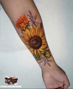 a woman's arm with a sunflower and lavenders tattoo on the wrist