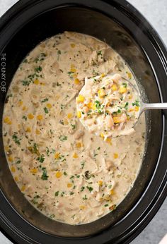 a crock pot filled with chicken and corn soup