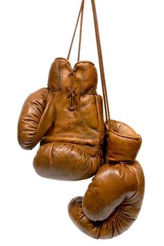 an old pair of boxing gloves hanging from a rope