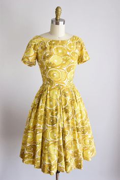 "Vintage 1950s novelty polished cotton sundress. Large lemon print in shades of yellow. Scoop collar, capped sleeves, darted bust and rolled nipped waist. Full skirt. Back metal zipper closure with bow for detail. State of garment | very good, light pulling at bust seams (which can be reinforced just consider the bust size), and a small hole under the left arm. refer to photos 5 & 6. please request further photos if needed. Measurements ✂--- best fit | xxs- xs bust | 33-34 \" shoulders | shy Cotton Lemon Print Dress For Garden Party, Yellow 1950s Style Dress For Garden Party, 1950s Style Yellow Dress For Garden Party, 1950s Style Short Sleeve Summer Dress, Retro Yellow Cotton Dress, Yellow Fitted Dress In 1950s Style, Fitted Yellow Dress In 1950s Style, Mid-century Cotton Summer Dress, Yellow 1950s Style Dress For Vintage Fashion