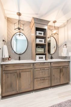 a bathroom with double sinks and two round mirrors on the wall above them is shown