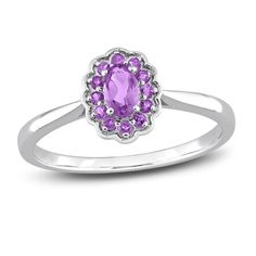 Embark on your forever journey together with this beautiful gemstone and promise ring. An exquisite oval-cut amethyst is simply radiant when embraced by a colorful halo of round-cut amethysts. The floral-inspired silhouette is fashioned in stylish sterling silver. Women's Rings, Delicate Rings, 3 Carat, Faceted Gemstones, Watch Necklace, Amethyst Gemstone, White Ring, Promise Ring, Sterling Ring