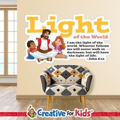 a child's room with a chair and wall decal that says light of the world