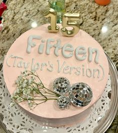 a pink cake with silver decorations and the number fifteen on it