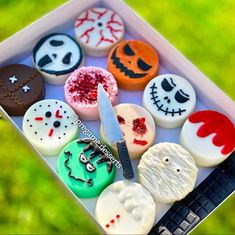 a box filled with lots of different types of decorated cookies on top of a table