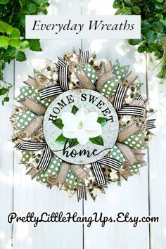 a wreath that says, everyday wreaths home sweet home with flowers and ribbon around it