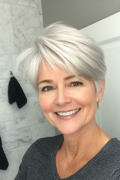 Click for More ➡️ | Save for Later ❤️This soft, silver-toned pixie features feathered layers that frame the face beautifully, offering a timeless and airy look perfect for enhancing natural silver tones. (Classic Silver Pixie with Feathered Layers - Short Pixie Haircuts For Older Women)