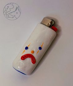 a bottle shaped like a face with eyes and nose painted red, white and blue