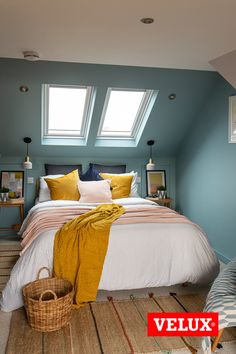 a bedroom with blue walls, white bedding and yellow throw pillows on the floor